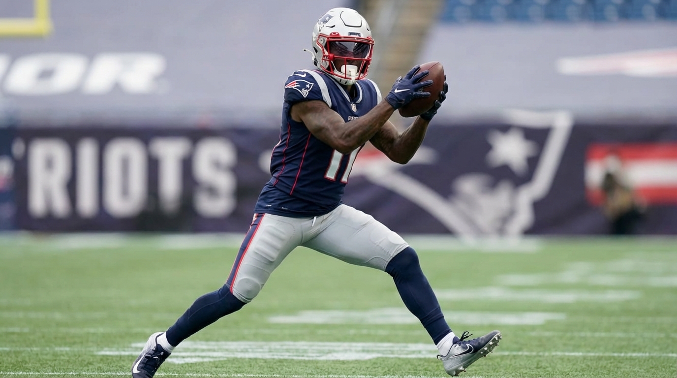 Illustration of a wide receiver in a Patriots-style uniform reaching to catch a football with a blurred stadium background